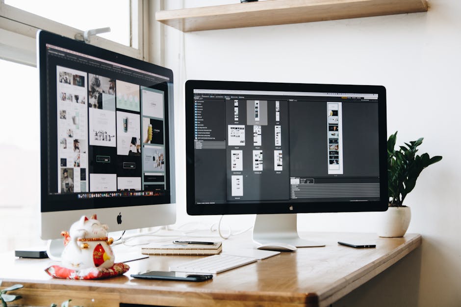 Stylish office workspace featuring dual monitors, a keyboard, notebooks, and decorative plant